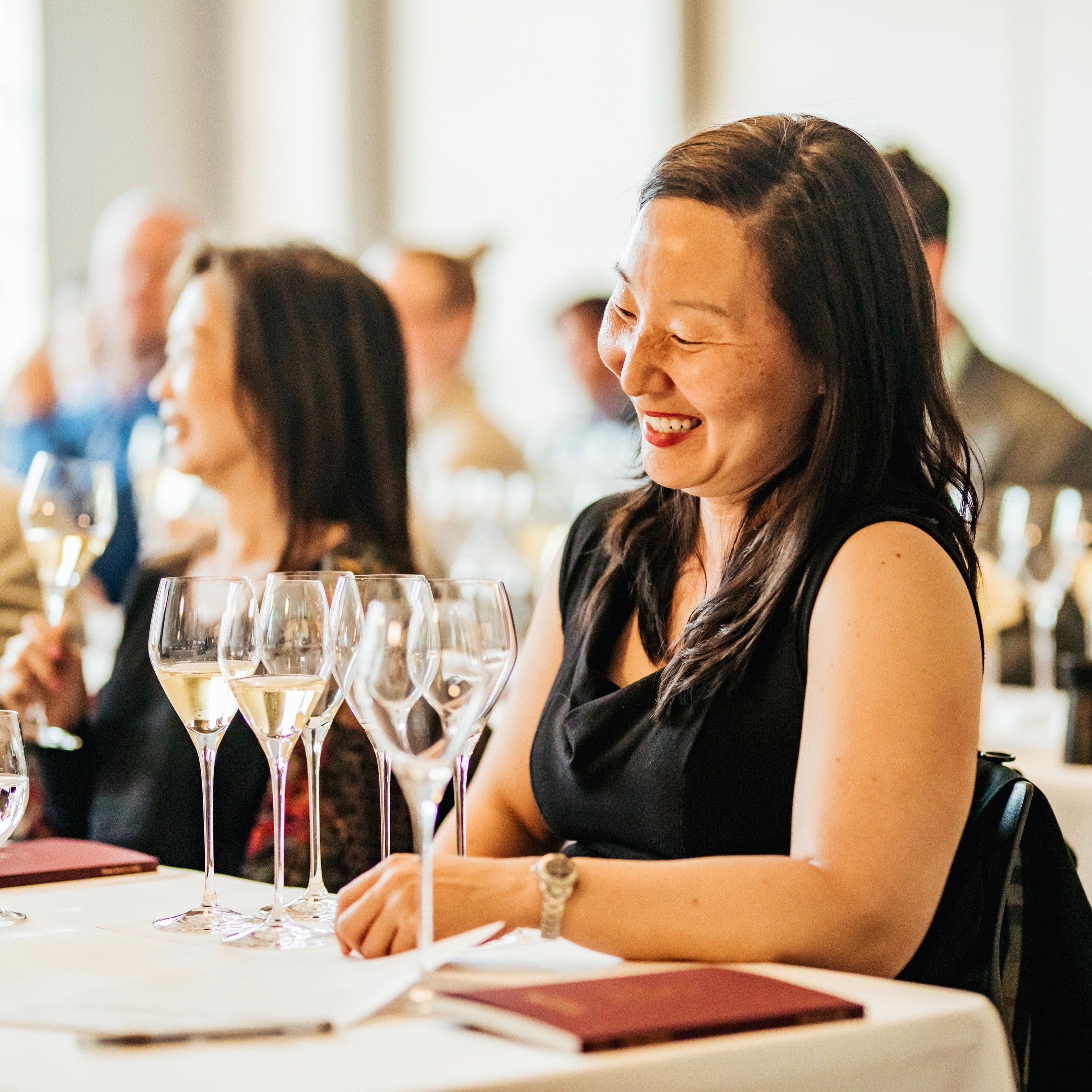 Woman in attendance to Wine 101 with San Francisco Wine School. A happy student in a wine education class in South San Francisco.