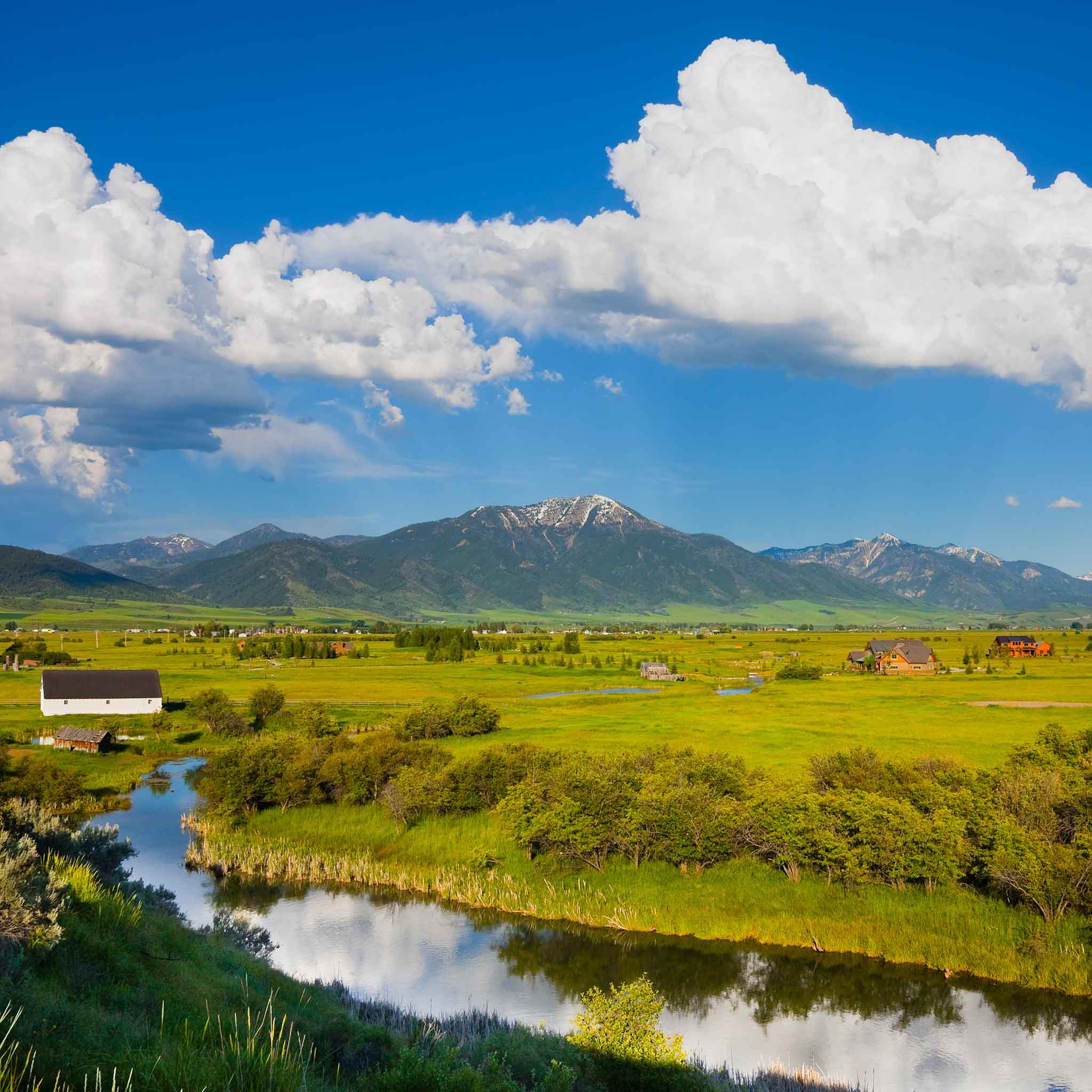 Scenic vineyard landscape with mountains, farmland, and rivers representing the wine regions and wines of Idaho and British Columbia.